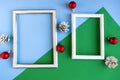 Two photo frames and Christmas decorations on color background, copy space for the text. Royalty Free Stock Photo