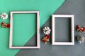 Two photo frames and Christmas decorations on color geometric background Royalty Free Stock Photo