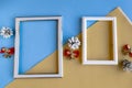 Two photo frames and Christmas decorations on color geometric background. Royalty Free Stock Photo