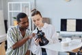 Two Photographers Choosing Images In Camera