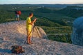 Two photographers takes pictures of nature on the rock