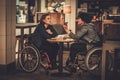 Two physically challenged women in a cafe Royalty Free Stock Photo