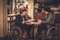 Two physically challenged women in a cafe Royalty Free Stock Photo