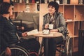 Two physically challenged women in a cafe Royalty Free Stock Photo