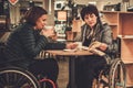 Two physically challenged women in a cafe Royalty Free Stock Photo