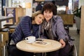 Two physically challenged women in a cafe Royalty Free Stock Photo