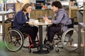 Two physically challenged women in a cafe Royalty Free Stock Photo