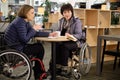 Two physically challenged women in a cafe Royalty Free Stock Photo