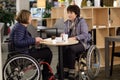 Two physically challenged women in a cafe Royalty Free Stock Photo