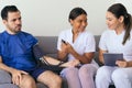 Two physicians checking a man`s blood pressure at home Royalty Free Stock Photo