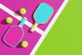 Two pickleball rackets and sports balls on the playground