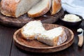Two piece of Classic Boule bread with butter on  wooden plate, horizontal Royalty Free Stock Photo
