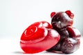 Two pieces of baby soap on a white background. One soap in the shape of brown teddy bear and another in the shape of a red heart