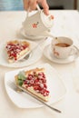 Two pieces of berry pie with whipped cream filling and a cup of tea Royalty Free Stock Photo