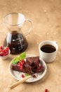 Two pieces of chocolate cake brownie decorated with red currant berries and mint for coffee on beige textured background Royalty Free Stock Photo