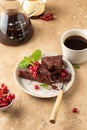 Two pieces of chocolate cake brownie decorated with red currant berries and mint for coffee on beige textured background Royalty Free Stock Photo