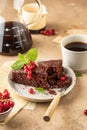 Two pieces of chocolate cake brownie decorated with red currant berries and mint for coffee on beige textured background Royalty Free Stock Photo