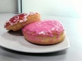 two pieces of donut served on a white plate on the table Royalty Free Stock Photo