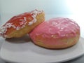 two pieces of donut served on a white plate on the table Royalty Free Stock Photo