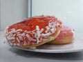 two pieces of donut served on a white plate on the table Royalty Free Stock Photo