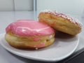 two pieces of donut served on a white plate on the table Royalty Free Stock Photo