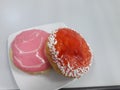 two pieces of donut served on a white plate on the table Royalty Free Stock Photo