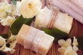 Two pieces of dry white soap with towels, roses and jasmine Royalty Free Stock Photo