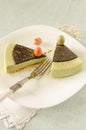 Two pieces of easter cake with tea matcha decorated chocolate ganache and sweet-stuff eggs on white plate Royalty Free Stock Photo