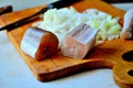 Two pieces of fish, chopped onions on a kitchen board - for cooking fish soup. Royalty Free Stock Photo