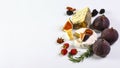 Two pieces of French soft cheeses Brie and Camembert with white mold and strong odor, served with fresh ripe figs close up Royalty Free Stock Photo