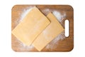 Two pieces of frozen puff pastry on a cutting board, top view. Isolate on a white background Royalty Free Stock Photo