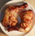 Two pieces of giant barbeque Grilled chicken legs serving on white ceramic plate
