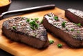 two pieces of grilled steaks on wooden chopping with herbs