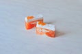 Two pieces of handmade orange soap