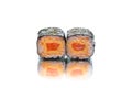 Two pieces of Maki sushi roll with salmon, hard cheese isolated on white background with reflection Royalty Free Stock Photo