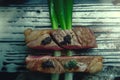 Two pieces of meat with blackberries and green onions on top Royalty Free Stock Photo