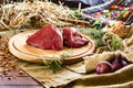 Two pieces of meat on a village round board. Near purple onions and greens. Country View Royalty Free Stock Photo