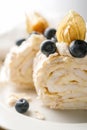 Two pieces of meringue roll with berries on a plate. Royalty Free Stock Photo