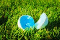 Two pieces of one white golf ball lay on green grass. Damaged golf ball, close up photo Royalty Free Stock Photo