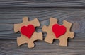 Two pieces of a puzzle with a red heart, unite into a single whole. Royalty Free Stock Photo