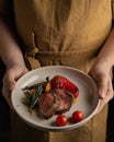 Two pieces of the roastbeef on plate in hand of chef Royalty Free Stock Photo