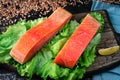 Two pieces of smoked fish Pink salmon on shale board. Fish close up. Royalty Free Stock Photo