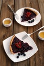 Two pieces of tart with black currant and blackberry filling and green tea