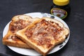 Two pieces of toast with Marmite spread on top Royalty Free Stock Photo