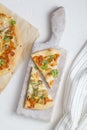 Two pieces of white pizza with artichoke and arugula Royalty Free Stock Photo