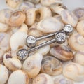 Two piercing jewelry on small seashells Royalty Free Stock Photo