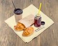 Two pies and tea in paper cup and plastic container Royalty Free Stock Photo