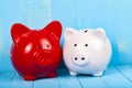 Two pigs piggy banks on a wooden background