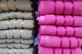 Two piles of beige and pink towels on the shelf. Royalty Free Stock Photo