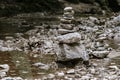 Two piles of stacked rocks, balancing in a riverbed, rock balancing